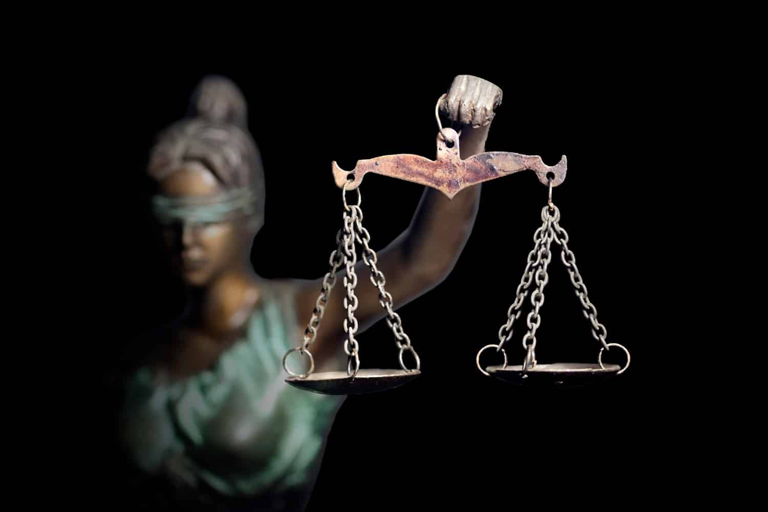 A statue of Lady Justice holding a set of scales.