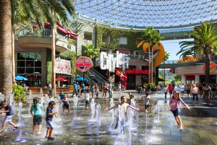 Kids play in a fountain in a mall