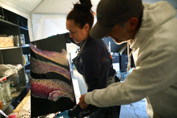 Artists Tiffany Bailey, left, and Scott Donovan, right, work on a project at Goodness Village on Tuesday, Oct. 31, 2023, in Livermore, Calif. Goodness Village provides the Tri-Valley's formerly unhoused neighbors a safe and supportive community to live independently. Since living at the village for the past two years Bailey and Donovan have started a small business named Fresh Start Art. (Aric Crabb/Bay Area News Group)