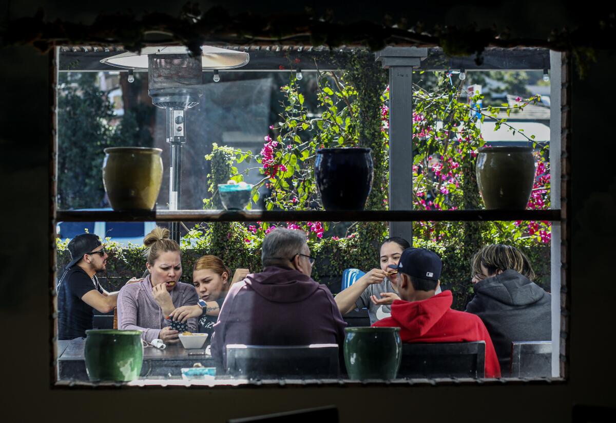 Diners sit in outdoor seating at Karina's Restaurant.