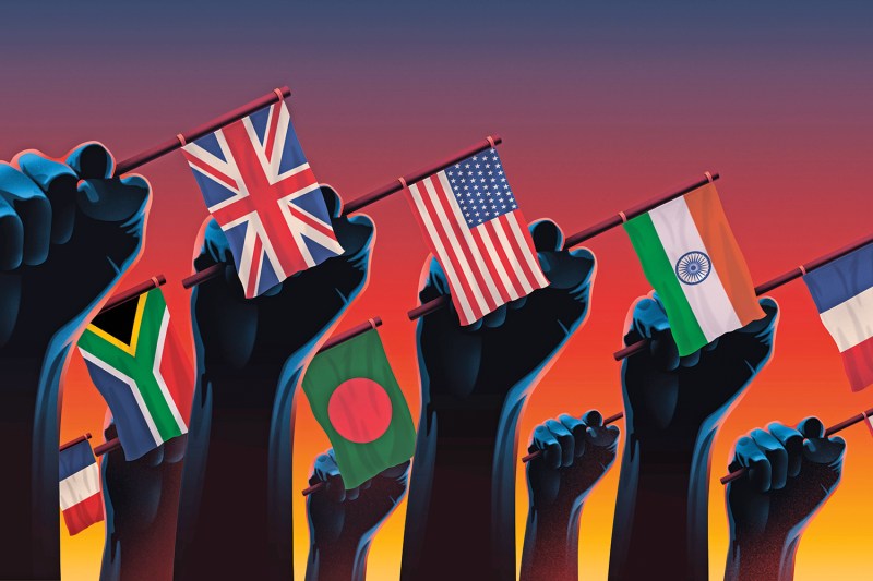 An illustration shows a row of clenched fists holding the national flags of the U.K., the U.S., Bangladesh, South Africa, and India for a story about nationalism in elections.