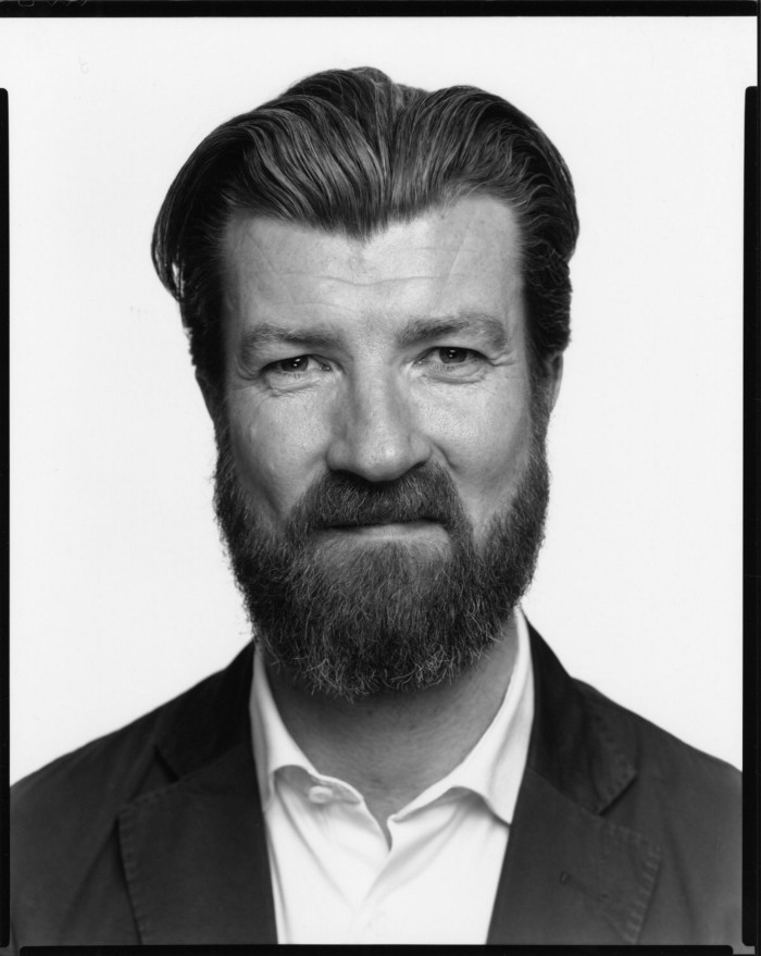 Photo of man with dark hair and beard