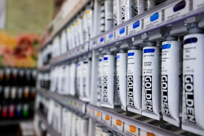 Dozens of shades and hues of rich acrylic paints line the shelves on Tuesday, Jan. 16, 2024, at Suder’s Art Store in Over-the-Rhine. The business celebrates its centennial this year.