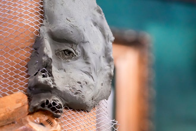 Part of a clay sculpted face greets customers near the front of the store on Tuesday, Jan. 16, 2024, at Suder’s Art Store in Over-the-Rhine. The business celebrates its centennial this year.