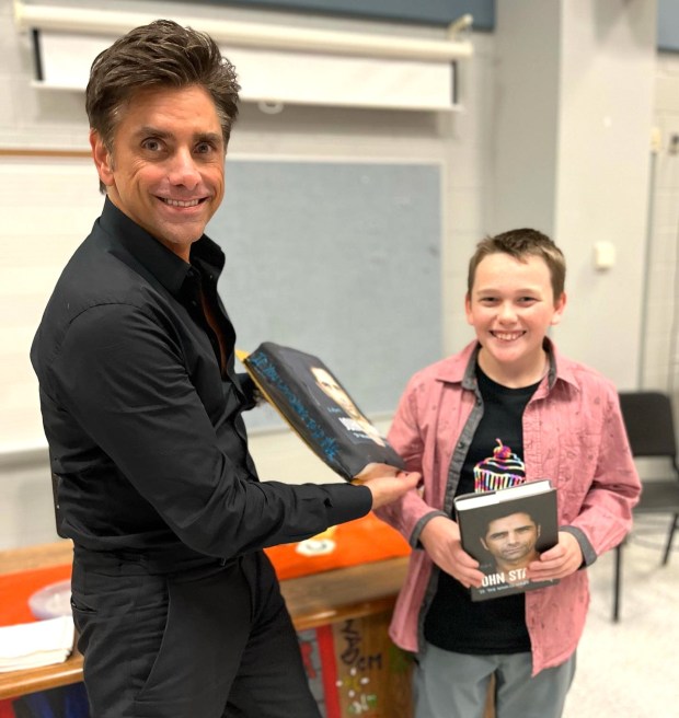 Cameron Livesay is pictured with John Stamos and the cake Livesay made for him. (Patrice Stair photo)