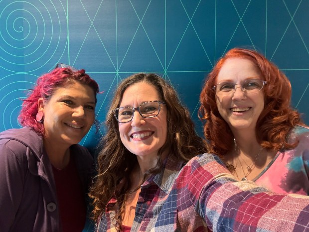 Felisha Bustos, a Greeley-area artist and teacher, center, poses with friends and artists Tara Fossum, left, and Selene Kaye, right, Saturday, Feb. 24, 2024 at LINC Library Innovation Center in Greeley. Bustos worked with Fossum and Kaye to organize HerStory 2024 including a reception for participating artists from 11 a.m. to 8 p.m. Saturday, March 2, 2024 at the LINC. (Courtesy/Felisha Bustos).