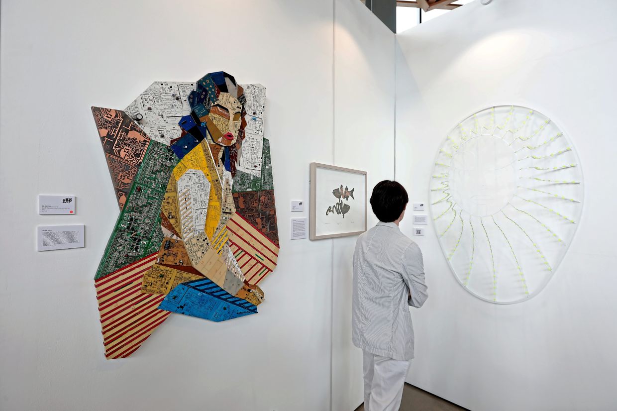 A series of artworks at the show (from left) 'After Untitled Hoessein Enas 1962' by Nor Tijan Firdaus, 'Siang Ikan?' by Mursyidah Zainal and 'Veiled Emergence' by Pamela Tan. Photo: The Star/Yap Chee Hong