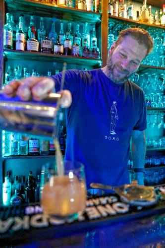 Owner Ed Mooers pours the Boom for Real cocktail at Valley Art Supplies on Friday night in Easthampton.