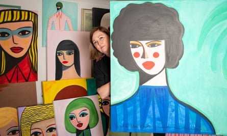 A close-up of several of McDaid’s paintings, with Margo peeping out from behind one of them