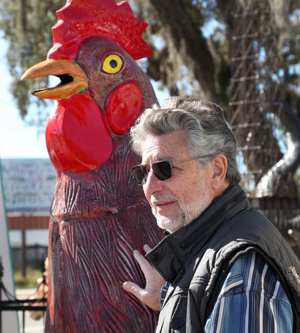 Carlos Pendola, owner of Barberville Yard Art, Thursday February 2024 with giant chicken.