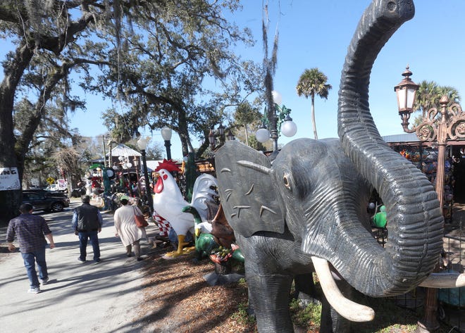 People walk past some of the life sized and bigger than life sized offerings at Barberville Yard Art Emporium, Thursday February 2024 .