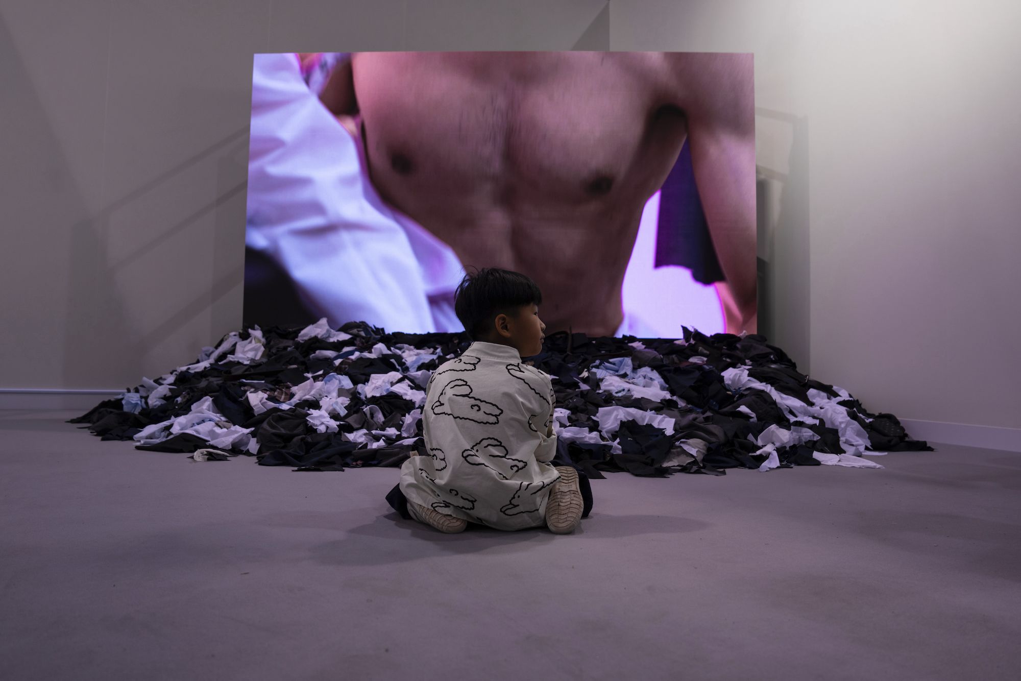 A child sits in front of Japanese artist Fuyuhiko Takata's video work 