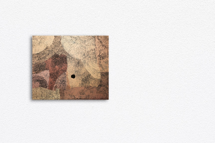 a brown painting on a white wall