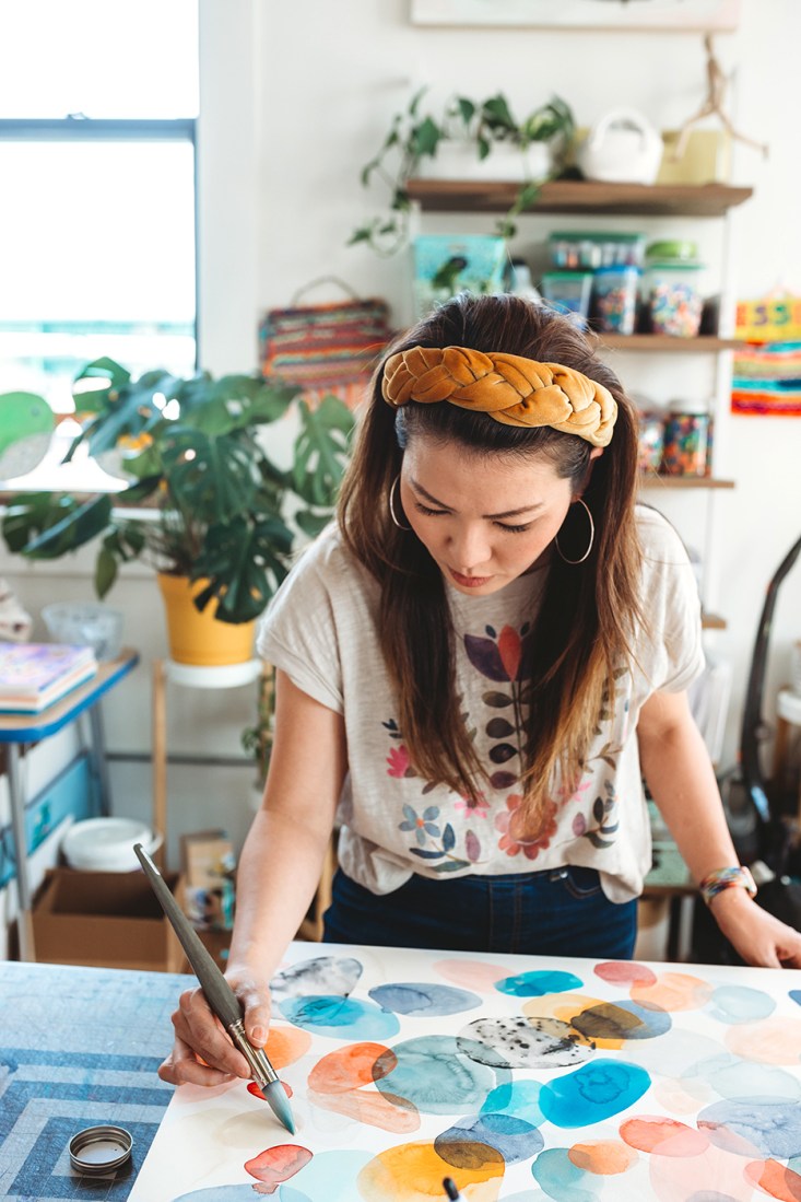 Sophia Moon painting in an art studio.