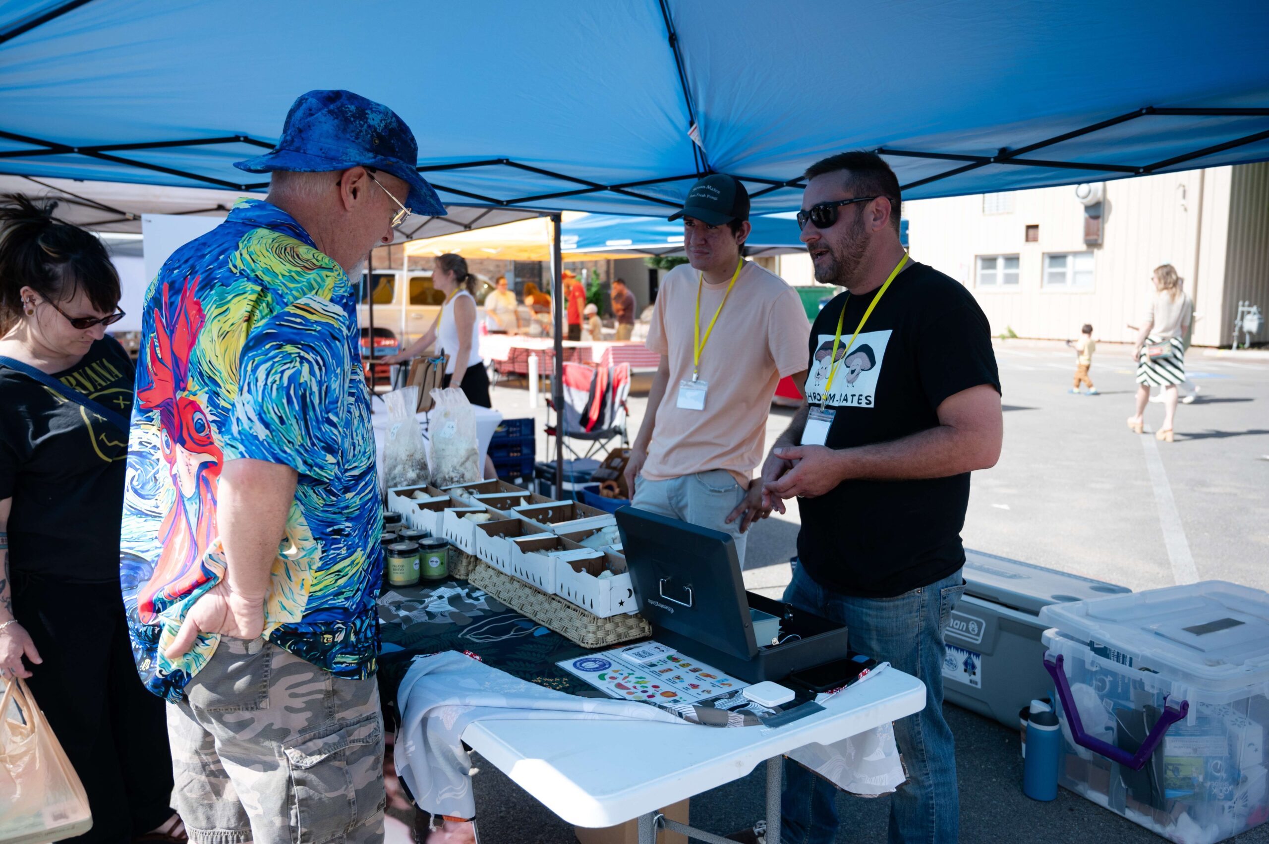 Shroom-Mates owner Casey Andre (right) chats with a customer, Brian Metzger (left) about the ways to cook oyster mushrooms during the first Farm and Art Market Downtown on Saturday, May 18, near City Lights Stage in Salina. <b>Photo by Olivia Bergmeier</b>