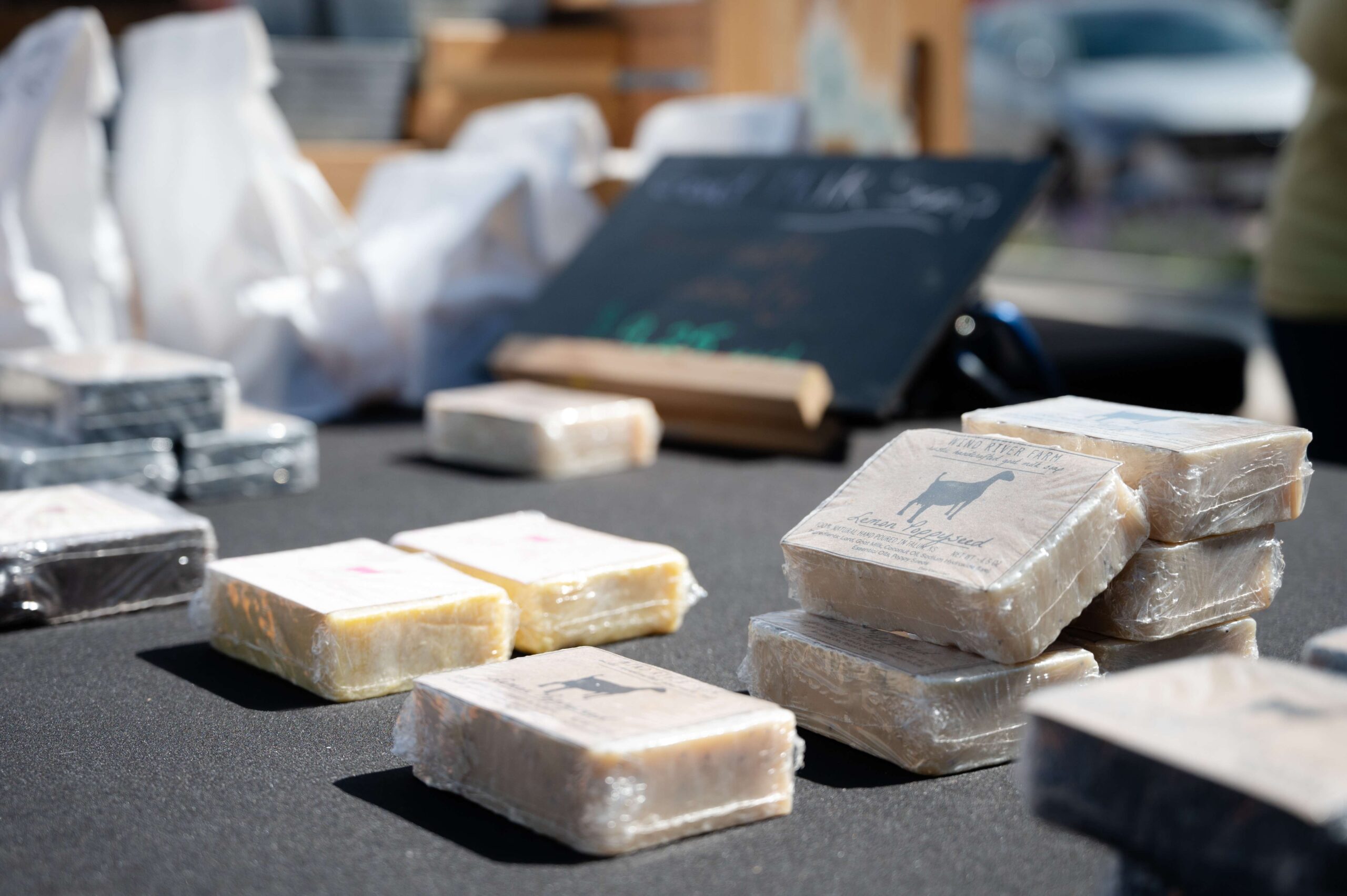 Wind River Farm goat-milk soaps lay out on a table ready for customers to browse during the first Farm and Art Market Downtown on Saturday, May 18, near City Lights Stage in Salina. <b>Photo by Olivia Bergmeier</b>