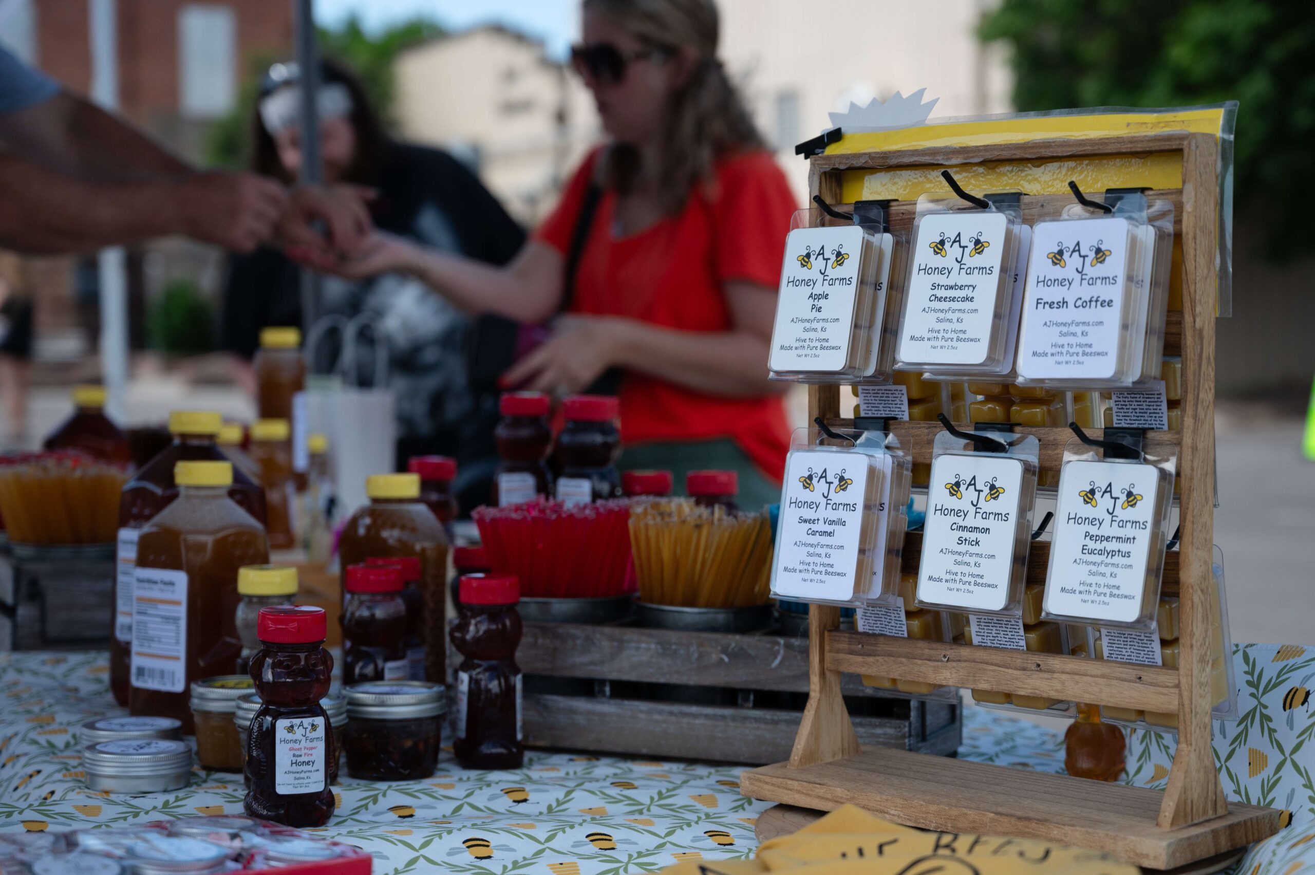 AJ Honey Farms, LLC, wax melts stand ready for customers to browse during the first Farm and Art Market Downtown on Saturday, May 18, near City Lights Stage in Salina. Photo by Olivia Bergmeier