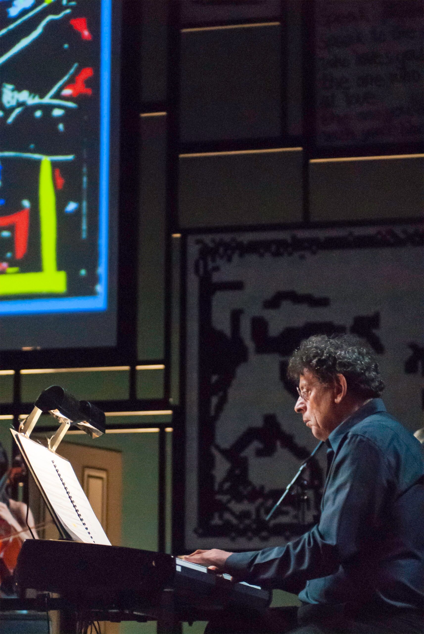 Philip Glass leads an ensemble of musicians in Book of Longing, a collaboration with poet and songwriter Leonard Cohen, in New York in 2007. Photo: Getty Images