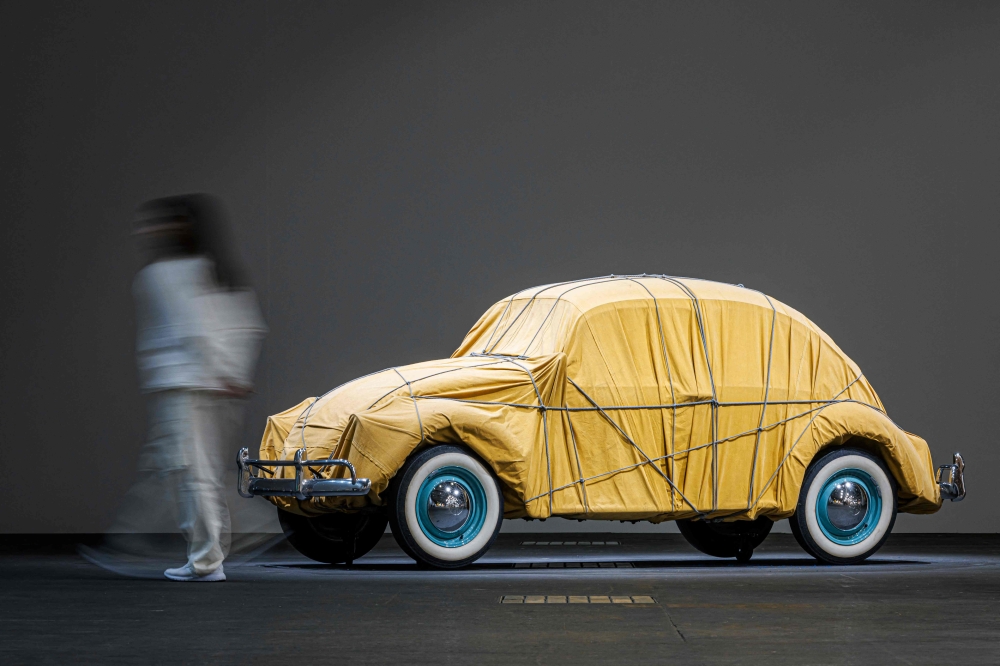 A visitor walks pass ‘Wrapped Volkswagen’ 1963-2014, by Bulgarian born artist Christo displayed at the Unlimited sector of Art Basel fair for Modern and contemporary art, in Basel June 11, 2024. — Valentin Flauraud/AFP pic