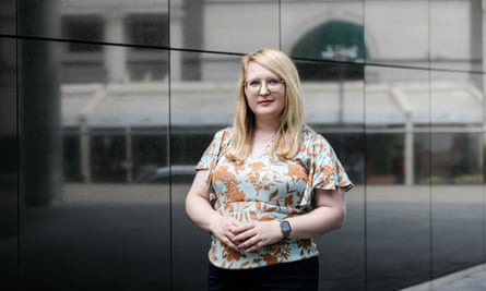 Agnieszka Kisielewska poses for a photo outside a modern office building