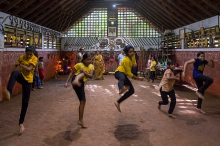 A line of girls captured mid-jump kick.