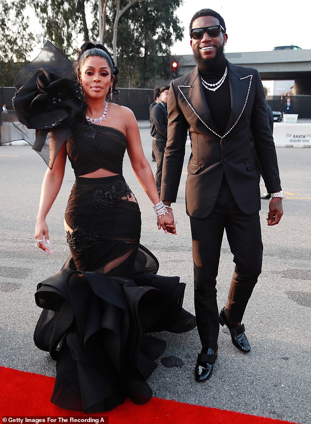 Pictured: Gucci Mane (right) and his wife Keyshia Ka'Oir. The pair have been married since 2017 and have three children together. This week, Ka'Oir defended her husband on Instagram after followers were quick to blame him for Enchanting's untimely death