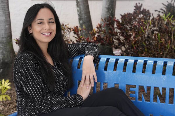 Ava Havidic, 18, poses outside her high school, Wednesday, April 24, 2024, in Tamarac, Fla. The Associated Press spoke with teenagers and young adults about their experiences on social media and what they wish they had known when they first got online. (AP Photo/Marta Lavandier)