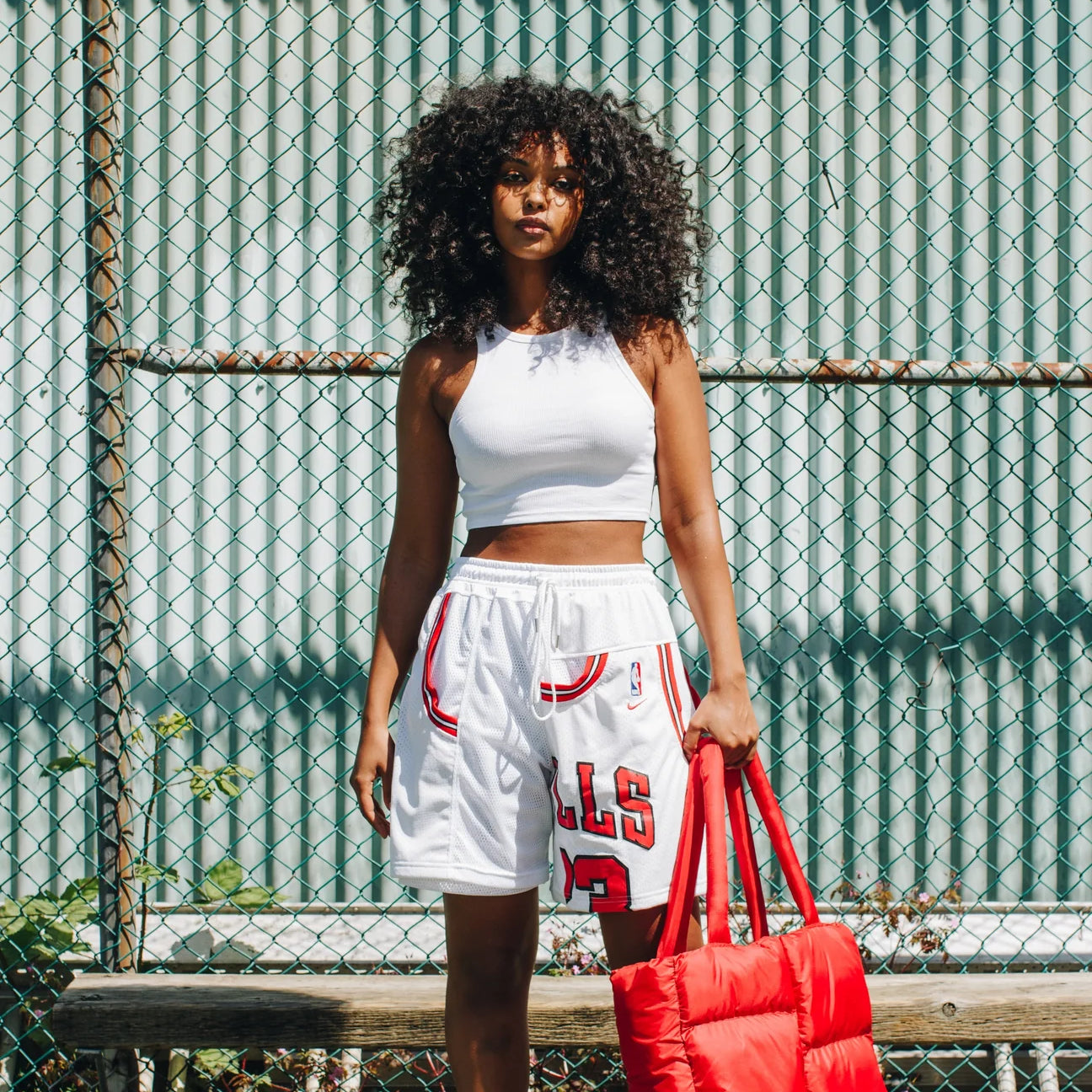 A woman models a pair of shorts made from upcycled jerseys as an example of a craft to make and sell