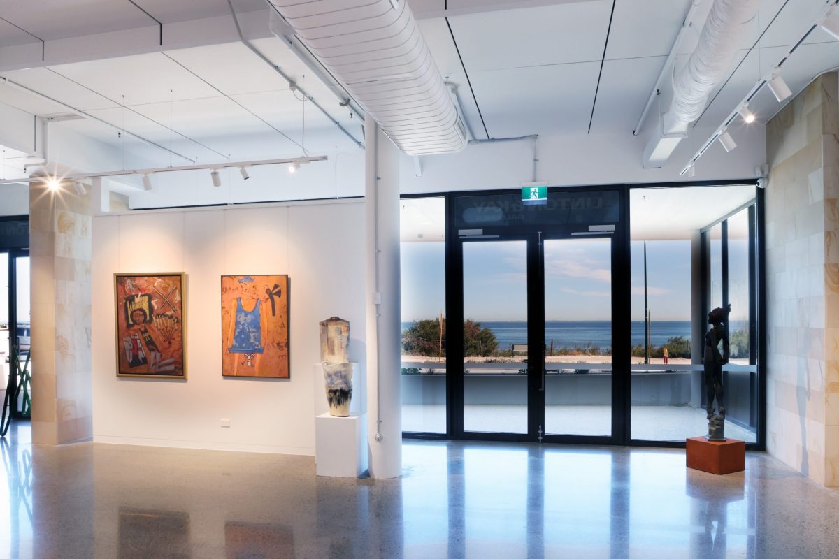 Linton&Kay Cottesloe. Photo: Johnathan Trask. A white-walled spacious gallery with the sea viewable through its front doors. 