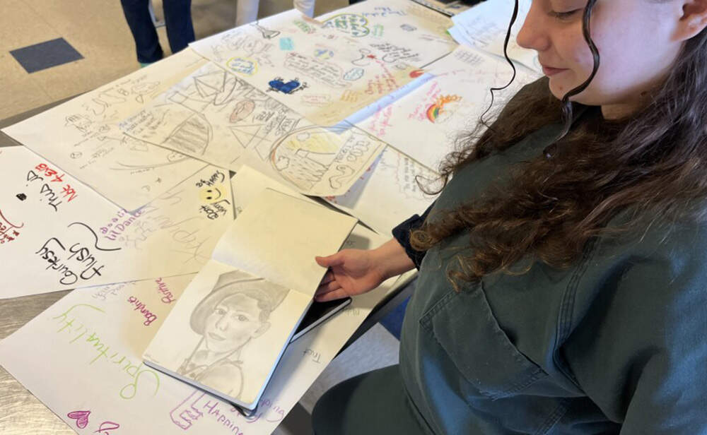 Tianna, 24, shows a sketch of her 7-year-old sister. (Patrick Flanary/CAI)