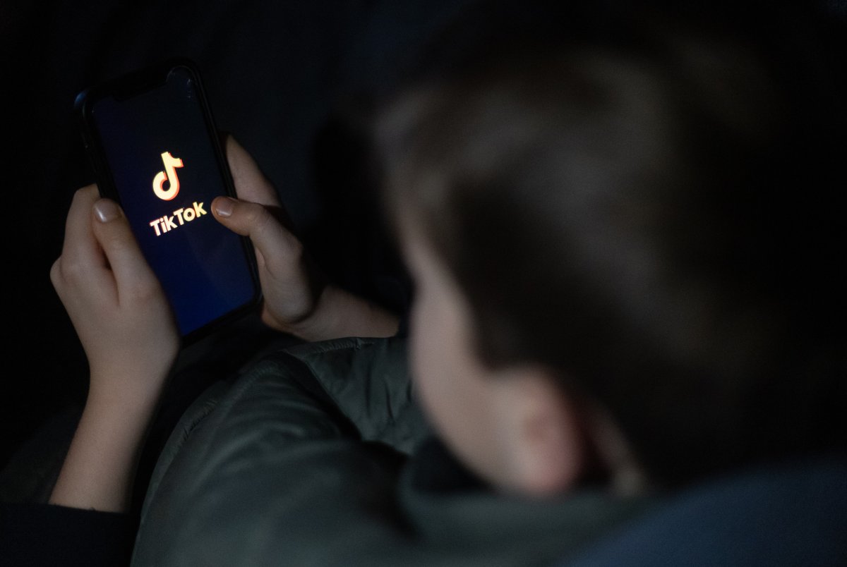 : A 12-year-old boy looks at smartphone