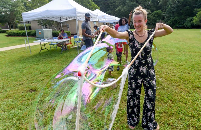 Lindsay Shedrick makes big bubbles using a special wand as she attends the Kentuck Art Market Saturday on the grounds of Kentuck’s new location on Jack Warner Parkway in Tuscaloosa.