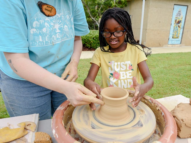 The Kentuck Art Market was held Saturday on the grounds of Kentuck’s new location on Jack Warner Parkway in Tuscaloosa. Amy Smoot shows Dallas Swanson how to use a pottery wheel.