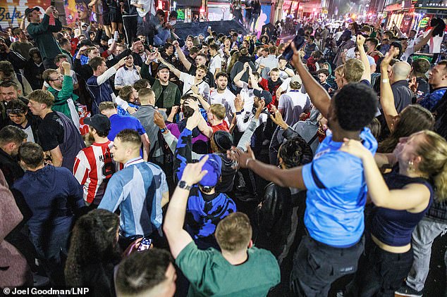 England fans chant and sing as they gather at Stevenson Square in Manchester on Wednesday