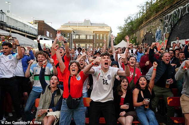 England fans at Peckham Arches in London react after Harry Kane scores on Wednesday night