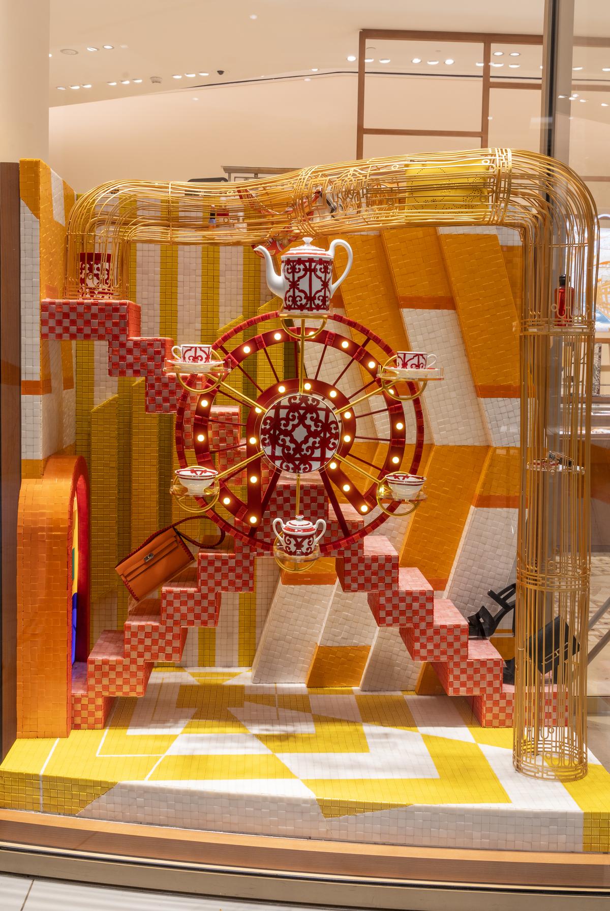 A ferris wheel attached to a stairway alongside a gilded ironwork elevator adorns one window A ferris wheel attached to a stairway alongside a gilded ironwork elevator adorns one window