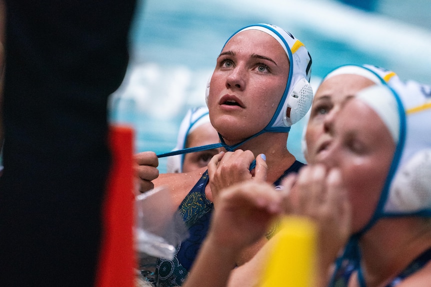 Tilly Kearns looks up at a coach from the pool