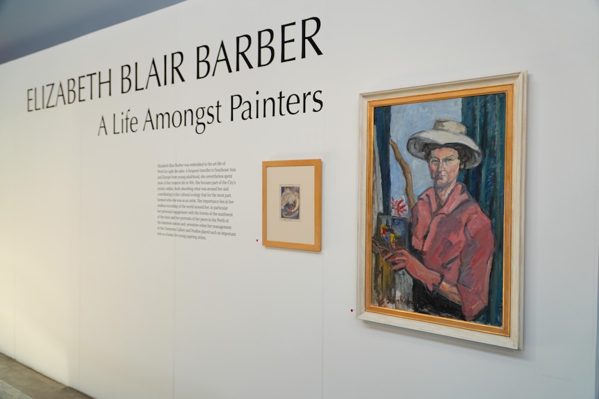 A portrait hanging on a gallery wall with the words 'Elizabeth Blair Barber a life amongst painters' written large alongside. 