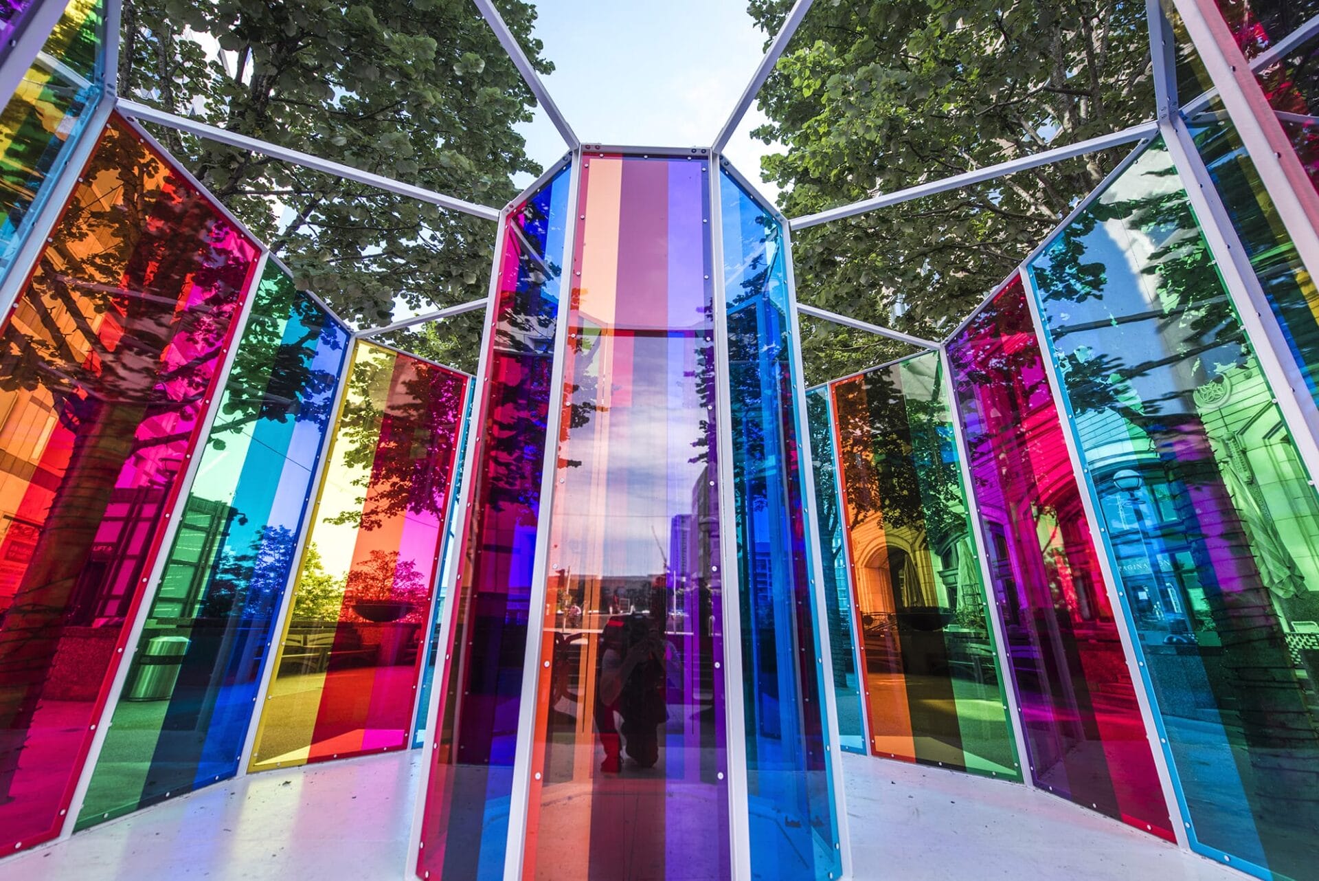 a brightly colored chromatic installation of translucent panels around a central column