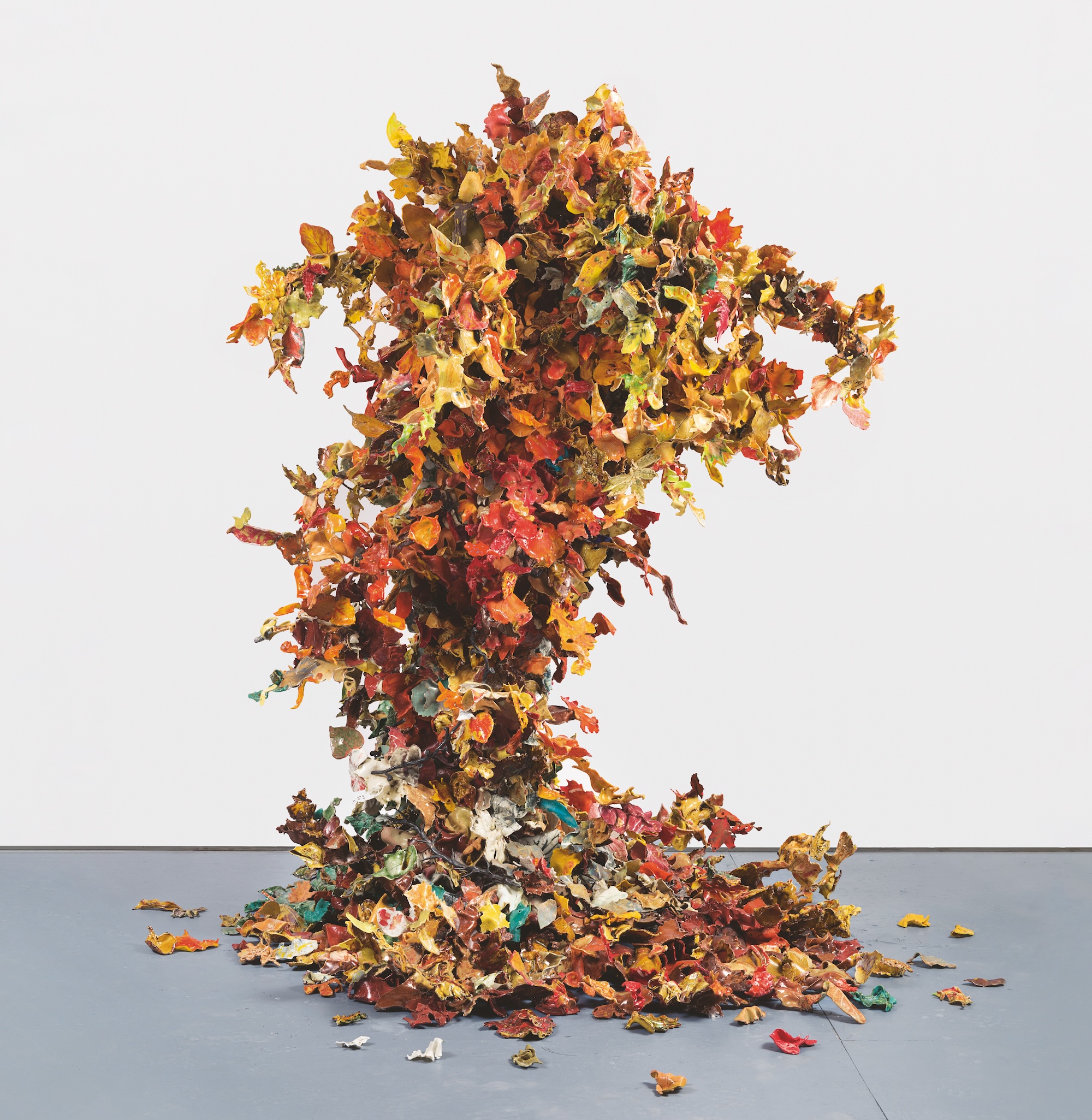 a freestanding sculpture of porcelain leaves as if they have been thrown up in the air and suspended there