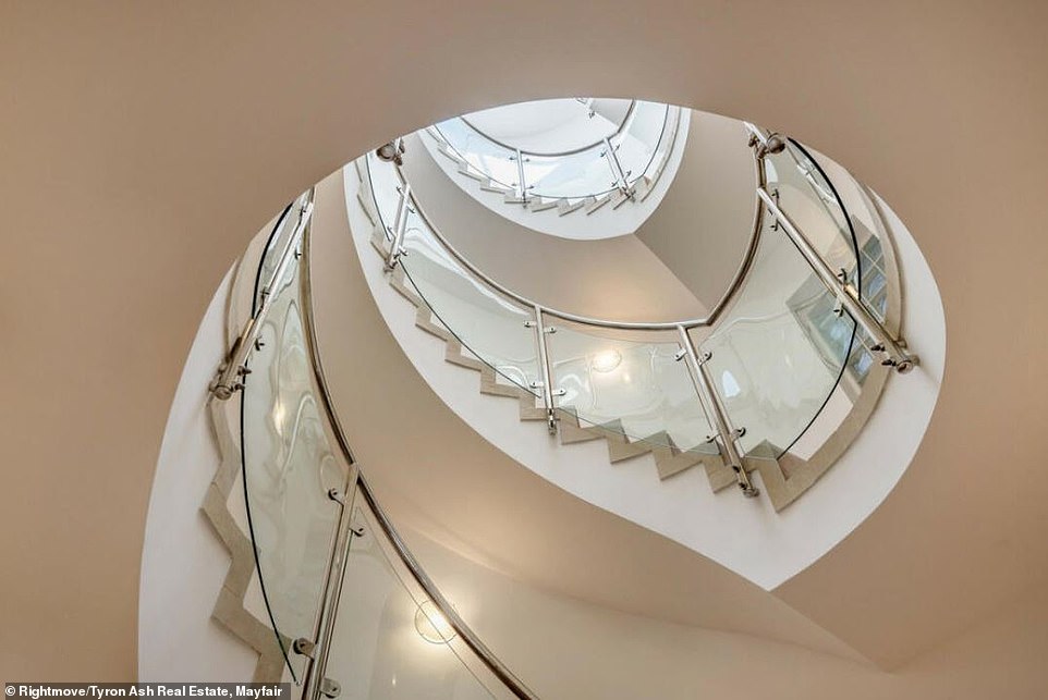 'All four floors in this simply outstanding residence are accessed via the lift or the impressive spiral staircase with glazed panelling flooded with natural lighting from the glazed dome ceiling above,' the listing reads