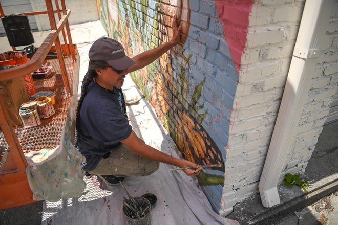 Juan Manuel Rozas, an artist from Miami, puts finishing touches on one of his pieces for KnoxWalls at Emory Place in Knoxville, Thursday, August 15, 2024. The immersive joint art collaboration from artists based nationwide will open to the public in Knoxville on Friday, Oct. 4.