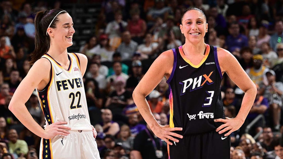 Caitlin Clark and Diana Taurasi stand on the basketball court