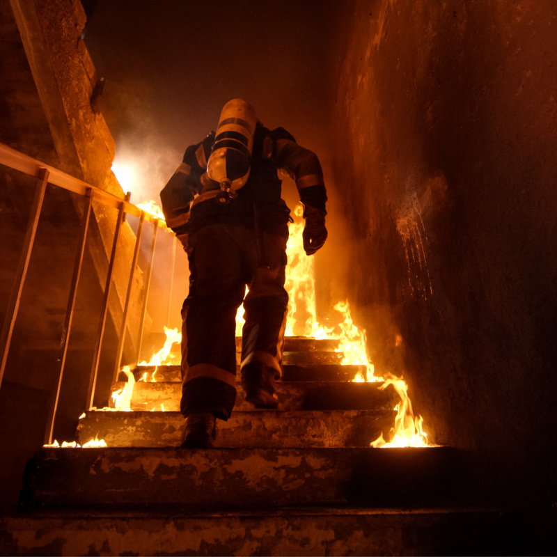 Firefighter climbs stairs in Burning BUilding.jpg