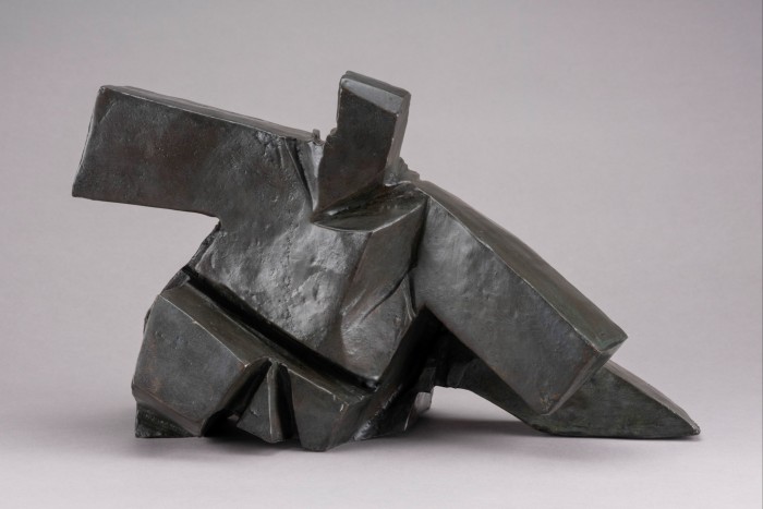 Chunky dark copper sculpture which looks like someone blocky wearing a kimono kneeling