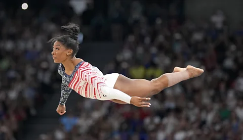 AP Simone Biles performing gymnastics routine at the Paris 2024 Olympics (Credit: AP)