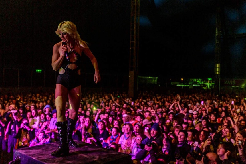 Amy Taylor stands on stage above thousands at Splendour In The Grass