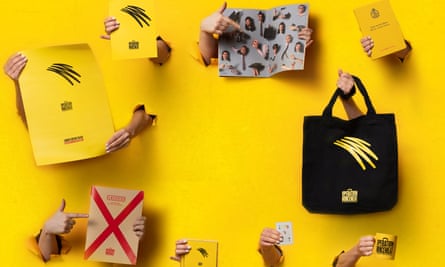 A selection of items, including notebooks, cups and bags on a yellow background 