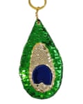 A keyring with sparkly green sequins, beige sequins and a blue patch 