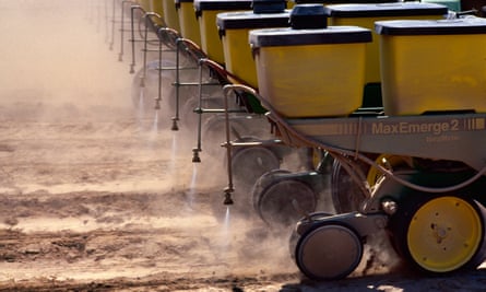 row of yellow planters spraying chemicals on ground